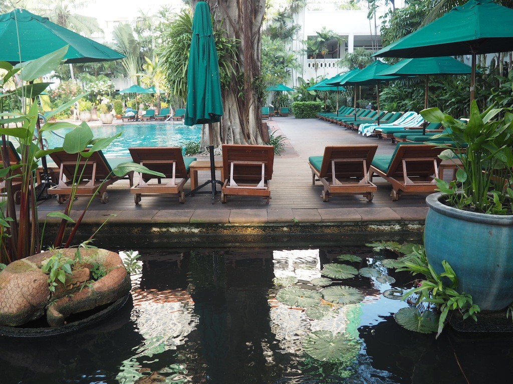 Water features and plant beds surround the pool area.