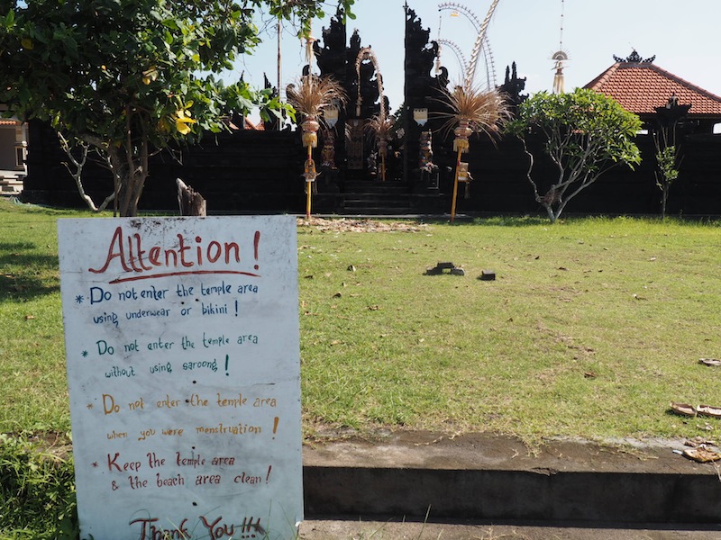 A sign at an unattended temple on Echo Beach, Canggu, lays out the local customs